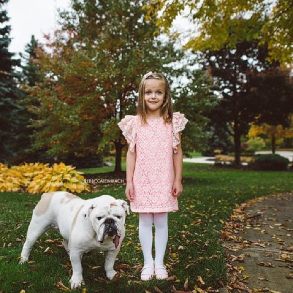 Bright pink dress with lace overlay.